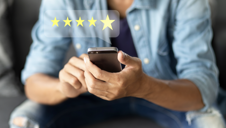 Person tapping a five-star rating on a phone